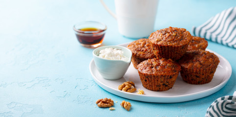 Carrot muffins with riccota cheese on a plate. Blue stone background. Copy space.