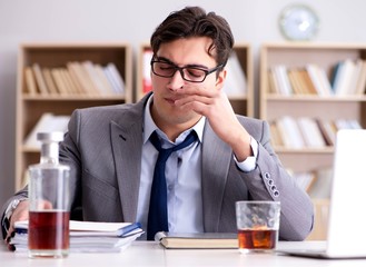 Young businessman drinking from stress