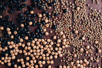 Legumes on vintage wooden table with free space for text