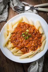 Pasta penne with tomato bolognese sauce.