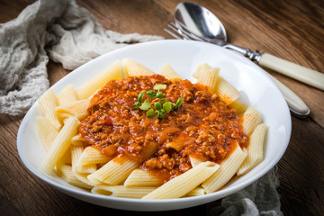 Pasta penne with tomato bolognese sauce.