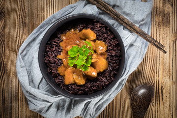 Thai red curry with chicken and black rice.