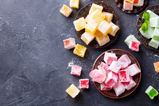 Assortment of Turkish delights. Dark background. Copy space. Top view.