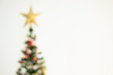 Defocused christmas background. Christimas tree, star, decoration and lights 
