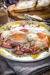 Fried eggs with sausage.