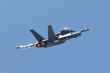 Tail view of a EA-18G Growler in beautiful light, with afterburners on