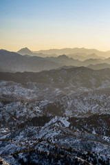 The view on the mountain top is covered with snow, pine trees in the winter are beautiful sunlight.