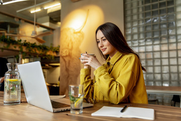 Attractive girl working on laptop during lunch time