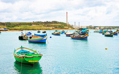 Fototapeta na wymiar Luzzu colorful boats at Marsaxlokk Bay Malta