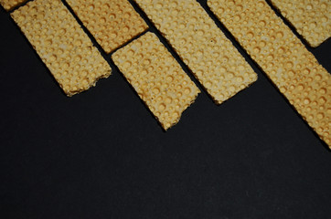 cereal breads on top on a black background with copy space horizontal orientation