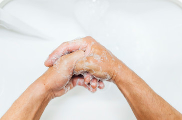 Washing hands rubbing with soap man for corona virus prevention, hygiene to stop spreading coronavirus.