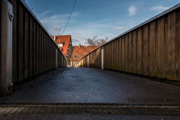 Fototapeta premium Little pedestrian bridge across the river with blue sky