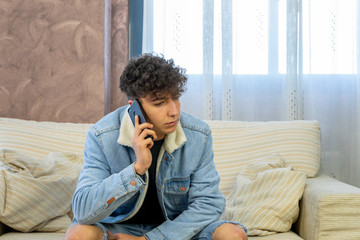 Young man posing on a living room sofa