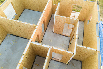 Construction of new and modern modular house. Walls made from composite wooden sip panels with styrofoam insulation inside. Building new frame of energy efficient home concept.