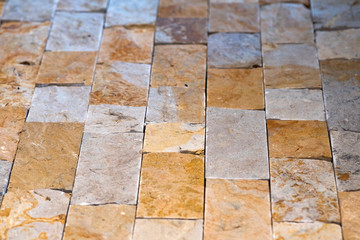 Closeup detail of limestone tiled wall of floor.