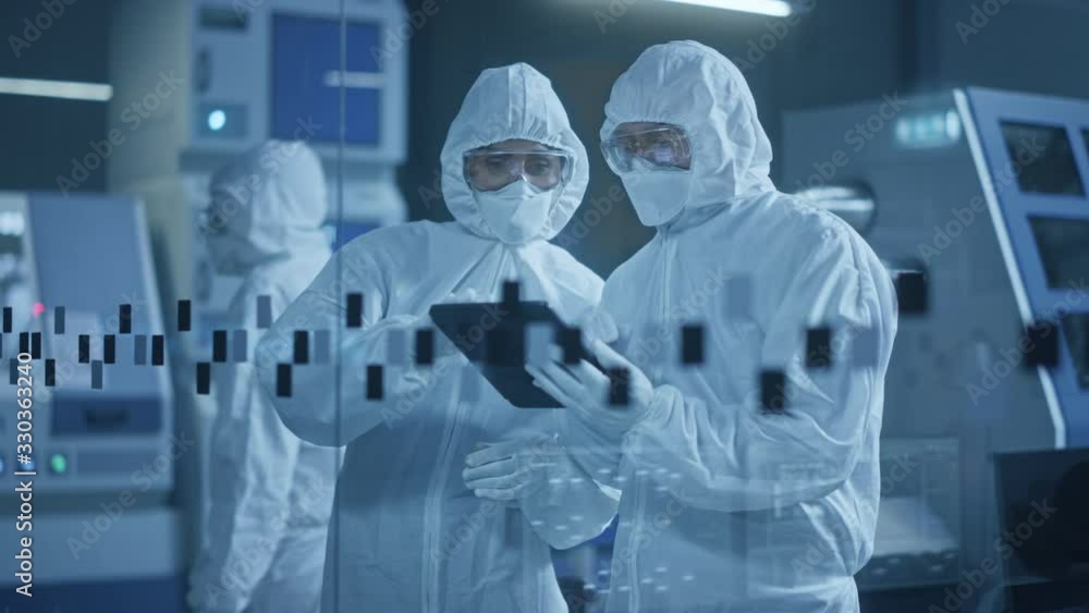 Poster factory cleanroom: engineer and scientist wearing coveralls, standing in workshop talk and use table