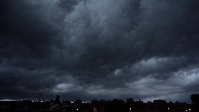 Dark ominous grey storm clouds. Dramatic sky. lighting in dark stormy clouds