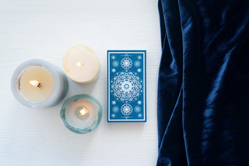 Tarot cards on the white wooden table background.