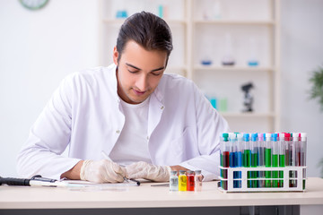 Young male chemist working in the lab