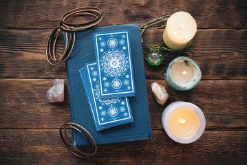 Tarot cards on the wooden table background.
