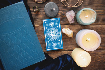 Tarot cards on the wooden table background.