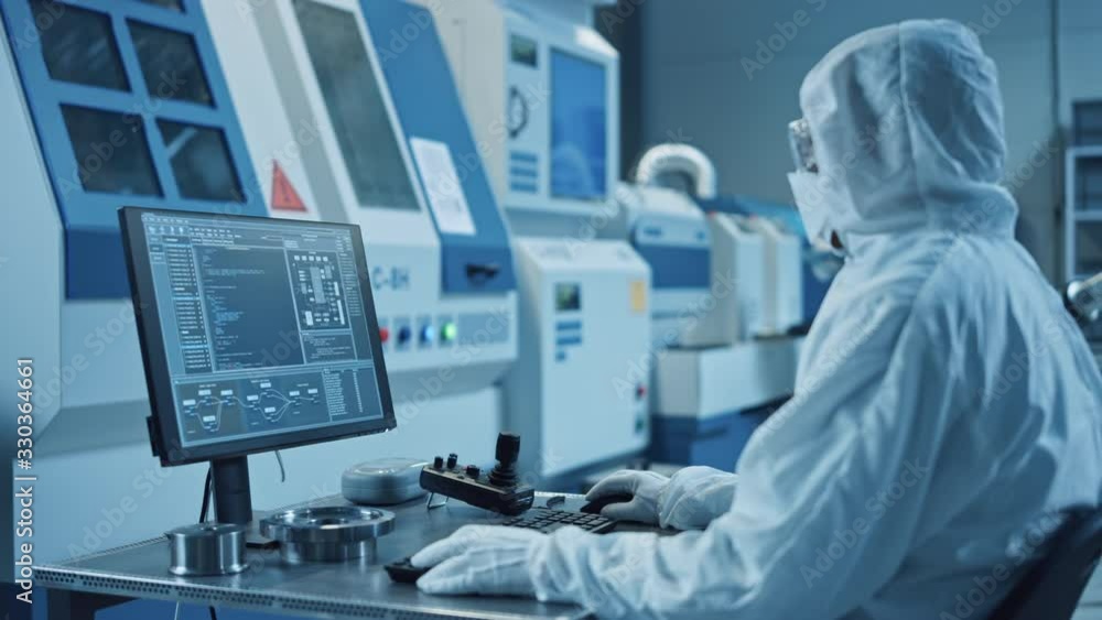 Aufkleber factory cleanroom: engineer wearing coveralls does system control on a computer, uses controller, sc