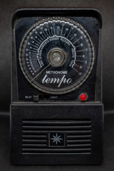 vintage metronome on black background