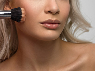 Close-up of woman's lips with fashion natural beige lipstick makeup. Macro sexy pale lipgloss...