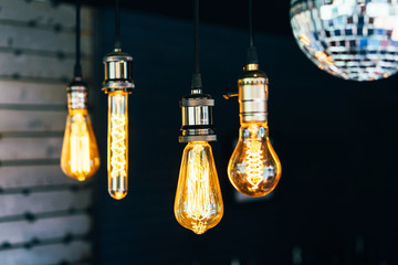 Close-up of light bulbs of different shapes on a dark background