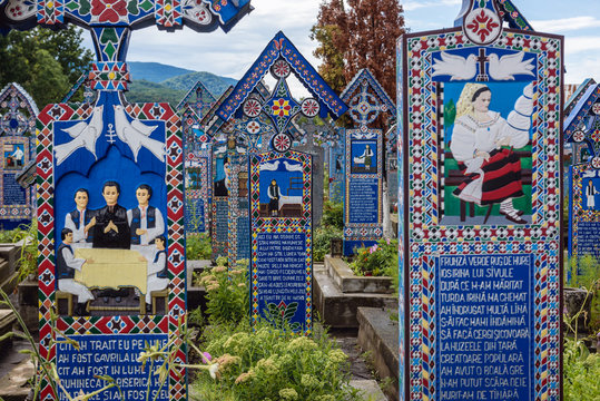 Sapanta, Romania - July 11, 2019: Characterstic painted graves on a famous Merry Cemetery in Sapanta village, Romania