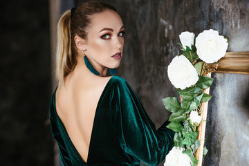 girl in an evening dress. blonde look from the back.