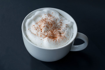 Coffee latte with milk foam and cinnamon