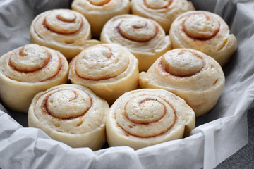 Obraz na płótnie Canvas Raw cinnamon rolls of yeast dough ready to be baked
