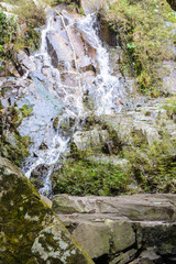 Fototapeta na wymiar The beautiful waterfalls, rapids and mountain streams in the tropical forest in Yanoda Park, Sanya city. Hainan, China.