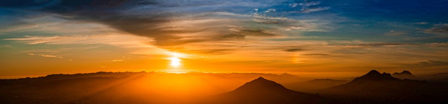 Panoramic Orange Sunset With Silhouetted Mountains