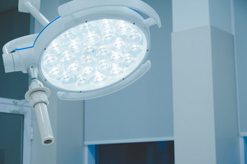 surgical lamps in operation room take with art lighting and blue filter. lighting fixture in a...