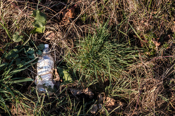 Plastic waste thrown away in the middle of nature