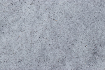 Obraz premium Background texture: dirty spring snow with soot particles and dirt. Ecology of Siberia and Russia.