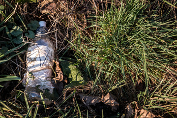 Plastic waste thrown away in the middle of nature