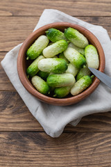 Small snack cocktail Dutch cucumbers Quirk variety on wooden background