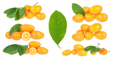Set of sliced and unpeeled ripe kumquat fruits with green leaves isolated on white background