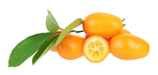 Composition with sliced and unpeeled ripe kumquat fruits with green leaves isolated on white background