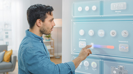 Handsome Young Man Walks Over to a Refrigerator. He is Changing Temperature on Smart Fridge Screen...