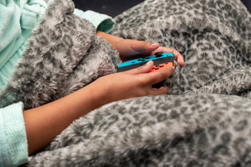 hands holding a games console controller 