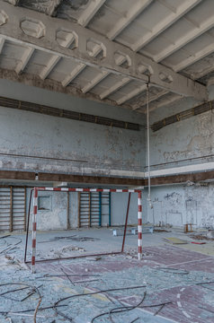 Abandoned sports hall with flaking paint in pastel shades