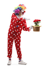 Clown holding a hat with red roses inside