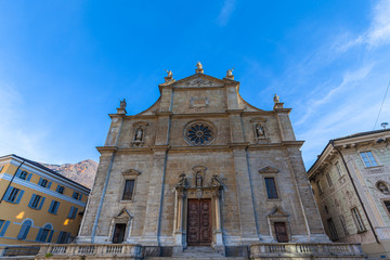 Close up front view of Collegiate of SS.Pietro e Stefano church with its imposing Renaissance facade with beautiful sculpture and decotation, in old town of Bellinzona, Ticino, Switzerland