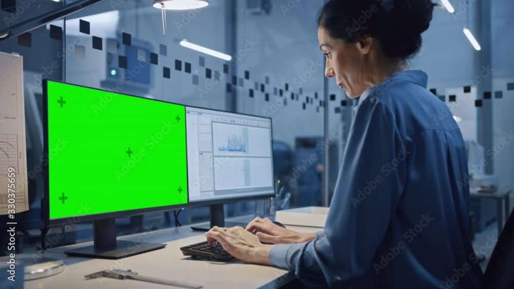 Poster factory office: portrait of beautiful and confident female industrial engineer working on computer, 
