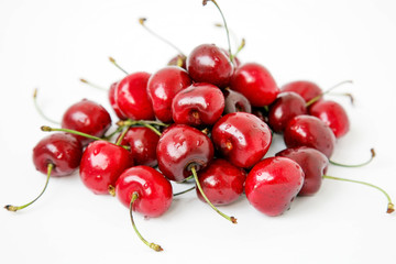 Fototapeta na wymiar Handful of red cherry on white background