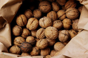 Cropped shot of walnuts. Abstract food background.  Walnuts in a paper bag, close up.